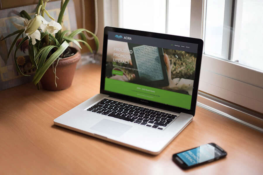 ACIRA website on a laptop and phone, displayed on a desk: the finished site for the association's members